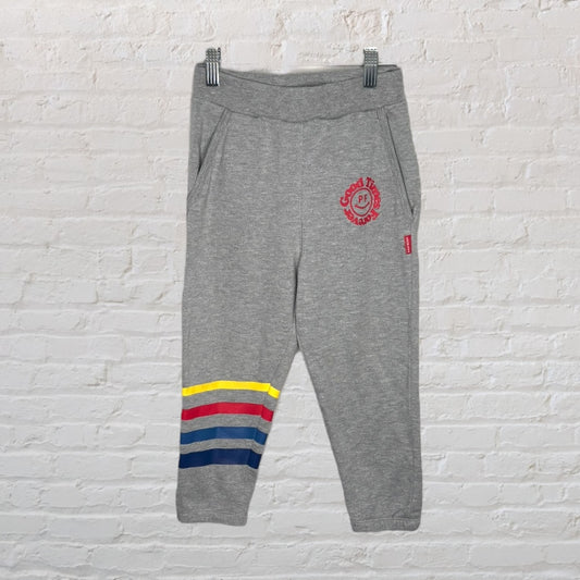 Gray sweatpants with colorful stripes at the bottom and PF Flyers logo, designed for casual comfort.