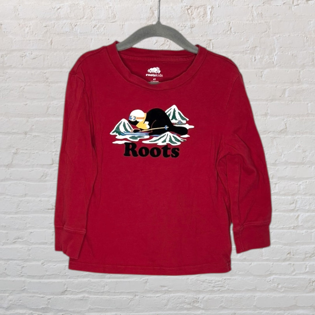 Red long sleeve Roots Kids tee with a graphic of a beaver skiing in front of mountains.
