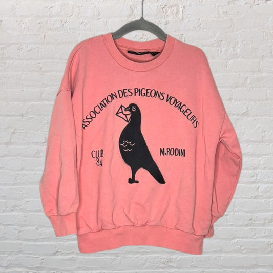 Pink sweatshirt with a pigeon graphic and 'Association des Pigeons Voyageurs' text, by Mini Rodini.