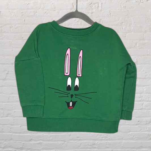 Green sweater with a cute cartoon bunny face graphic, featuring pink ears and a cheerful expression.
