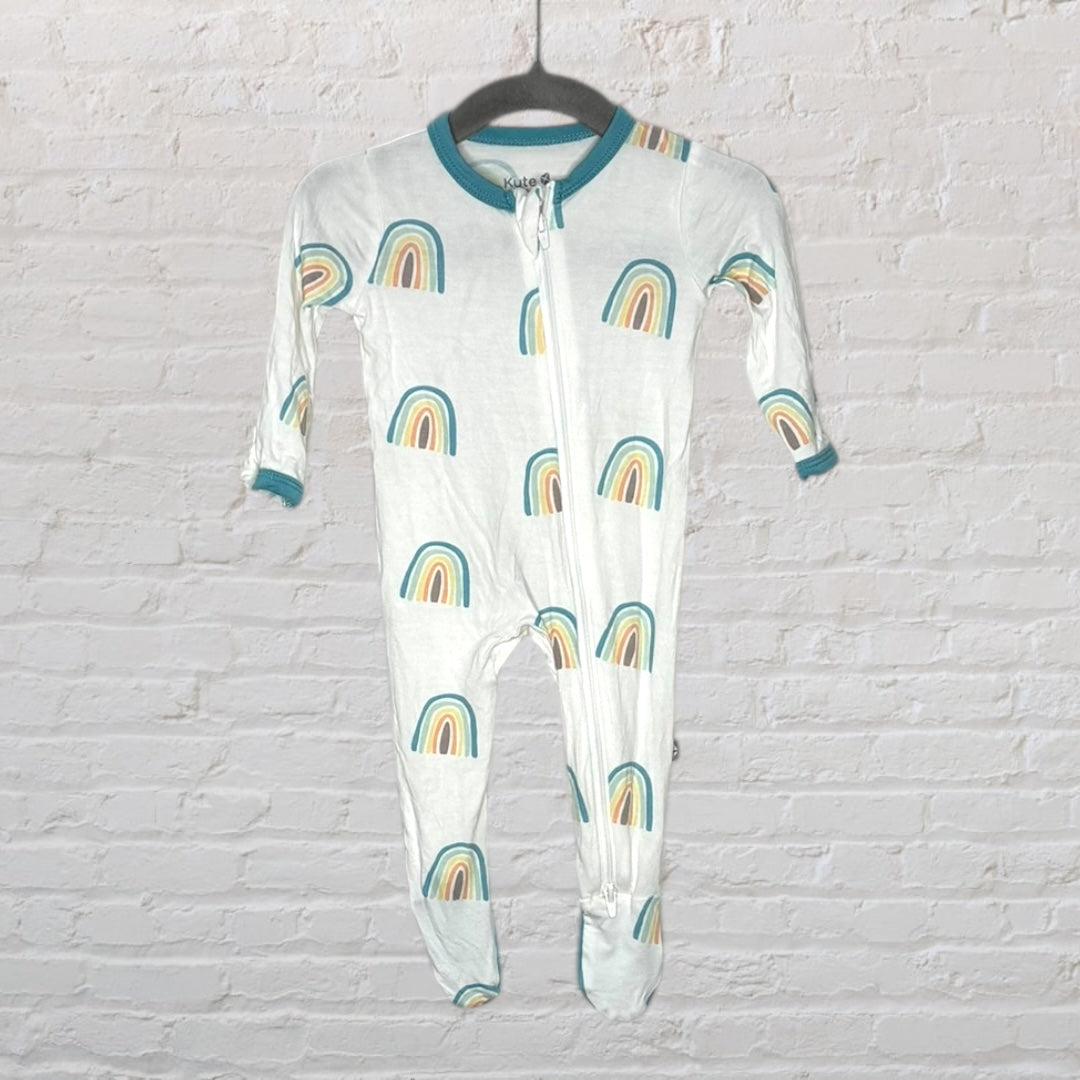 White baby sleeper with rainbow pattern and teal trim, featuring a front zipper, hanging on a hanger.
