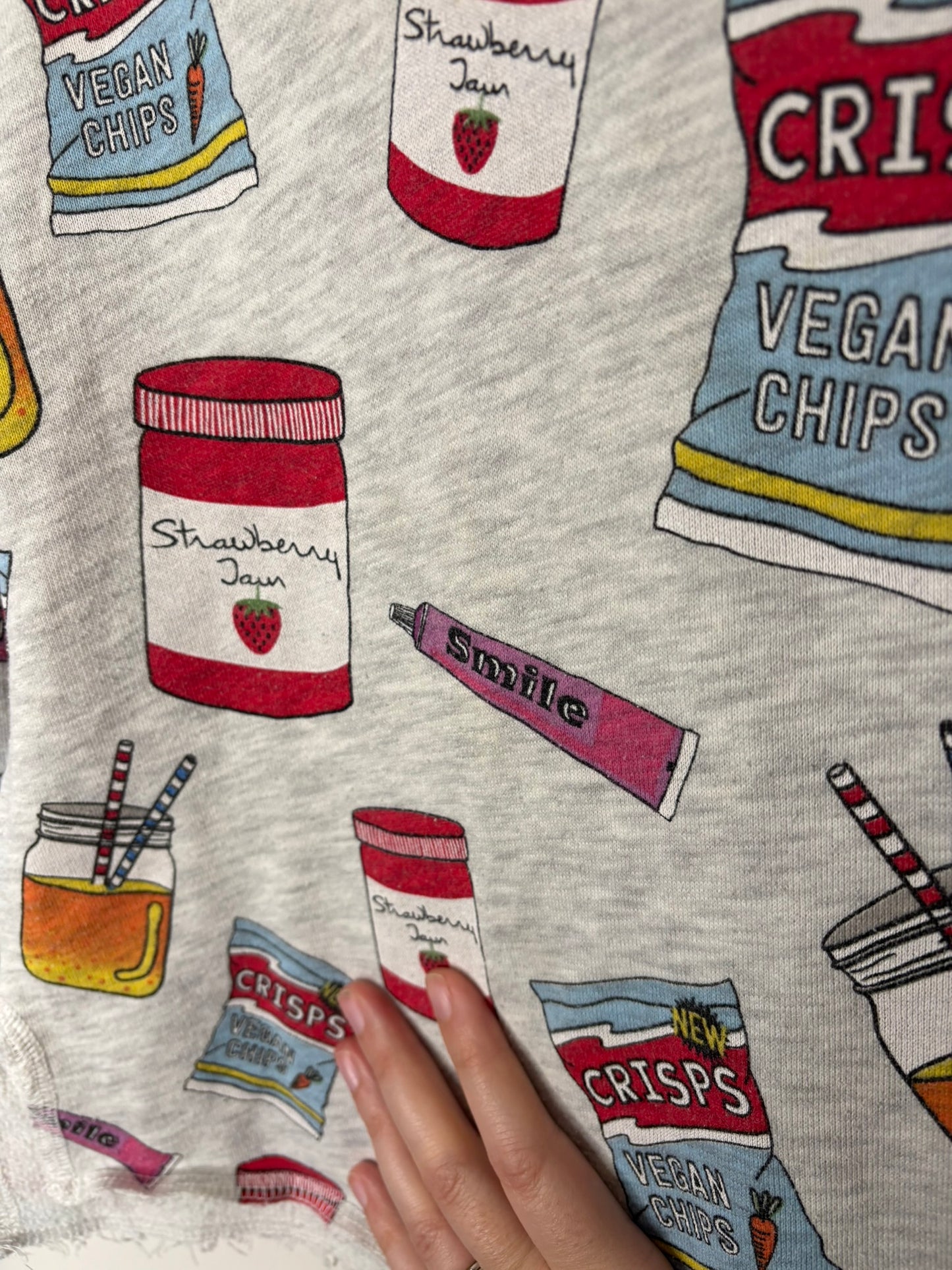 Grey long sleeve shirt with colorful snack graphics including crisps, jam, and drinks.