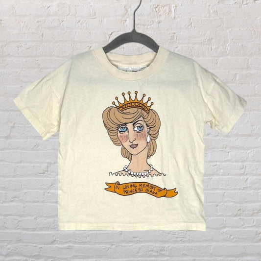 Cream T-shirt with a graphic cartoon image of Princess Diana, featuring a crown and a commemorative banner.