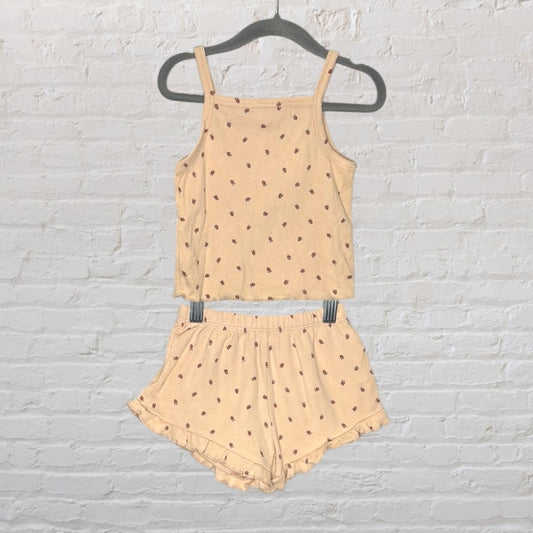 Beige sleepwear set featuring a tank top and shorts with a delicate floral print, displayed on a hanger.