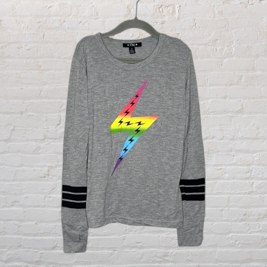 Grey sweatshirt with a rainbow lightning bolt graphic and black stripes on the sleeves.