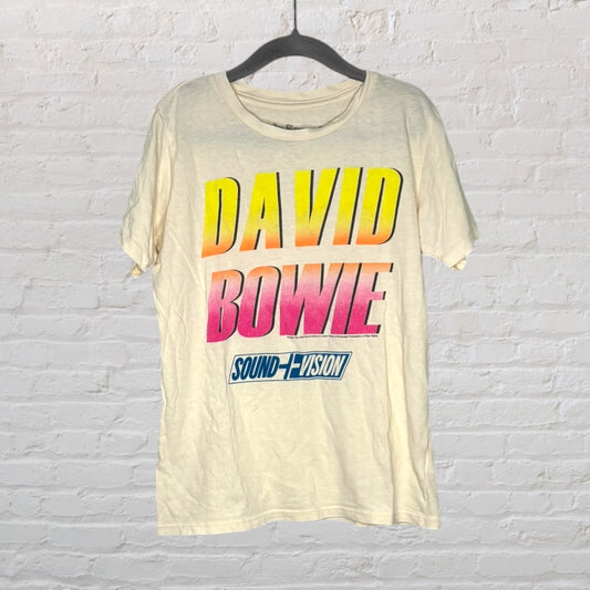 Cream-colored T-shirt with 'David Bowie Sound + Vision' printed in a vibrant gradient design.