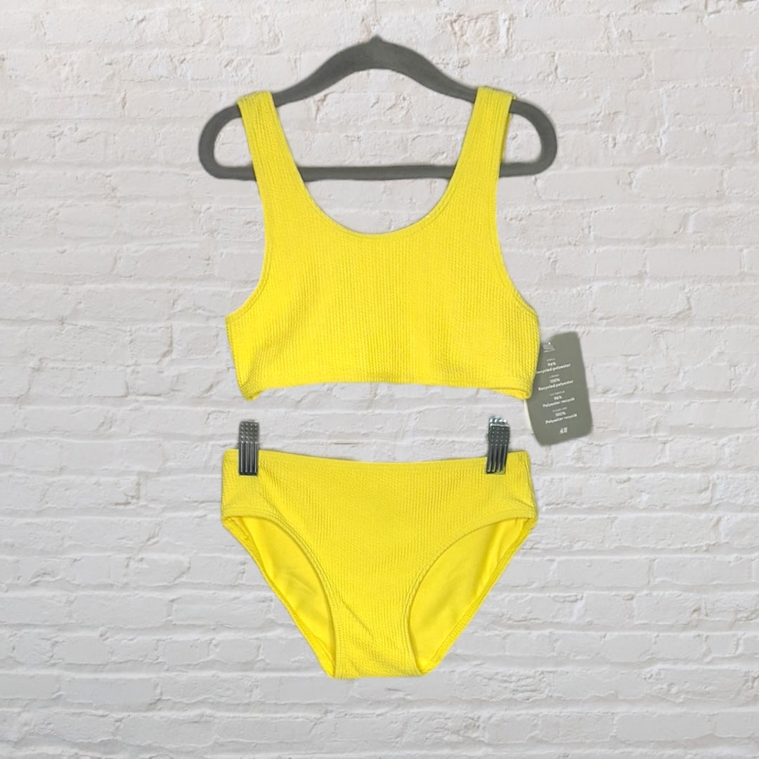Bright yellow textured bikini set with tank-style top and matching bottoms, displayed on a hanger with tags.