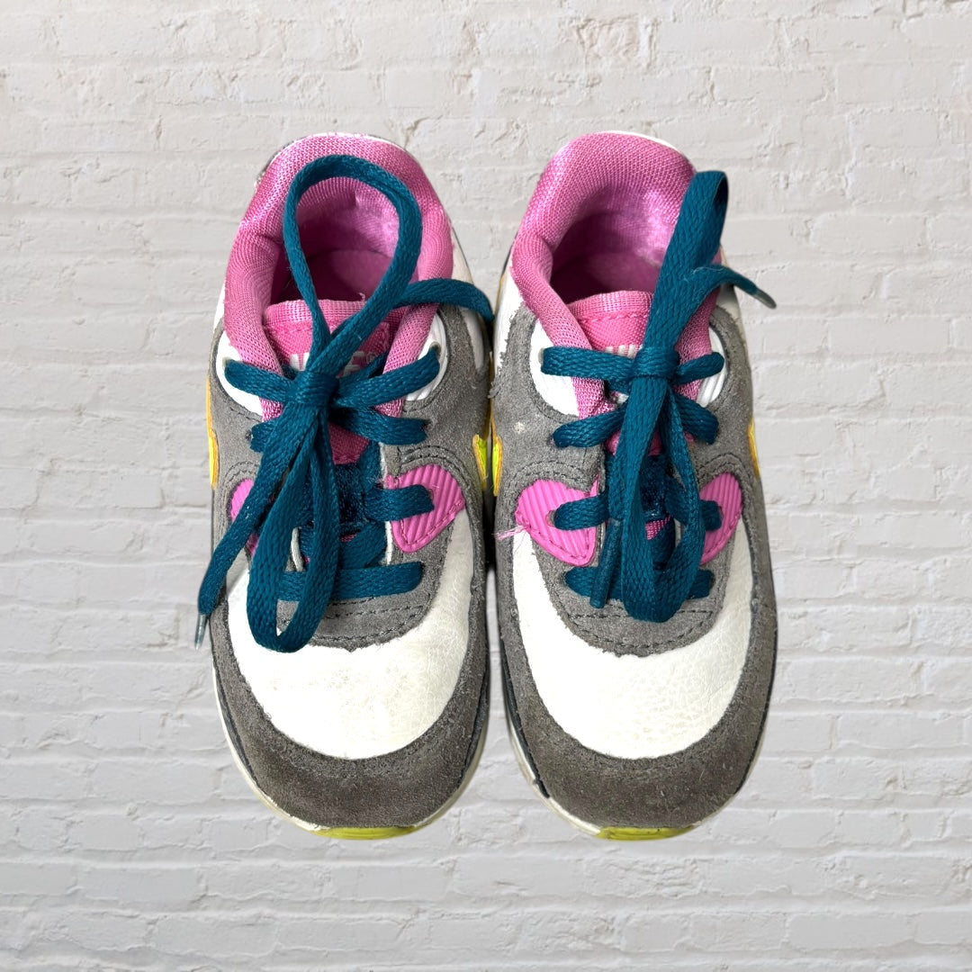 Nike Air Max kids' sneakers in gray, pink, and yellow with blue laces.