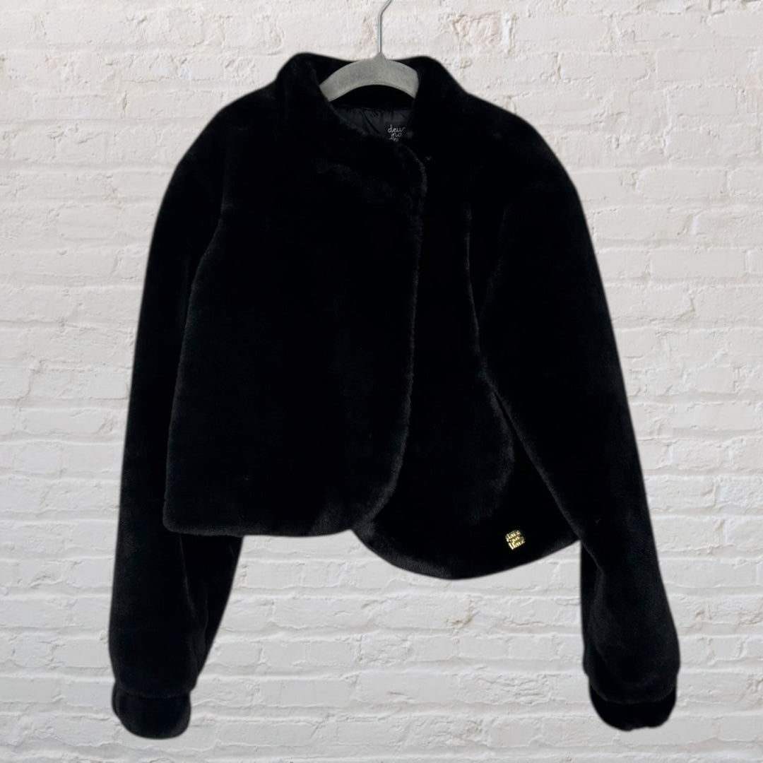 Chic black faux fur jacket with a luxurious texture and elegant design, displayed on a hanger.