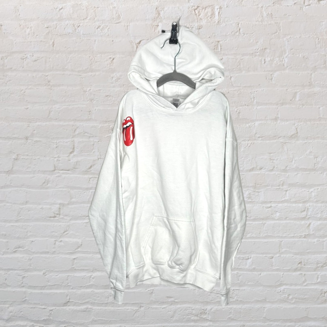 White hoodie featuring a large red tongue graphic on the back, displayed against a white brick wall.