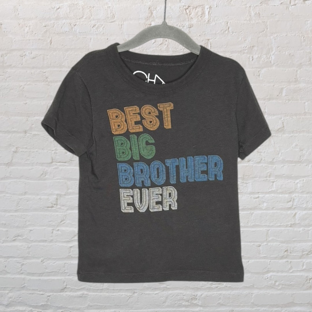 Black T-shirt with colorful 'Best Big Brother Ever' text printed on the front, hanging on a gray hanger.