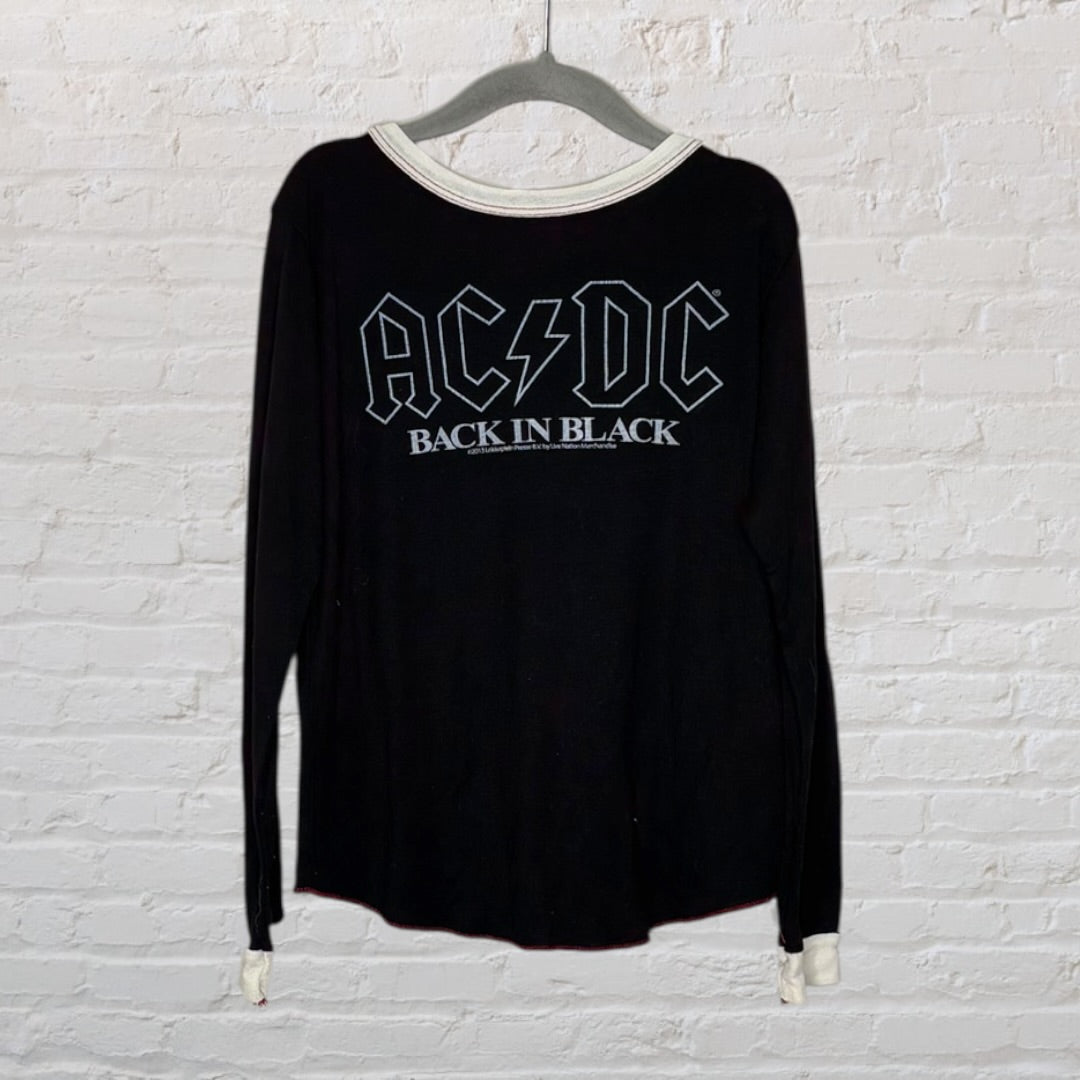 Black long sleeve AC/DC 'Back in Black' band t-shirt with white neckline hanging on a hanger.