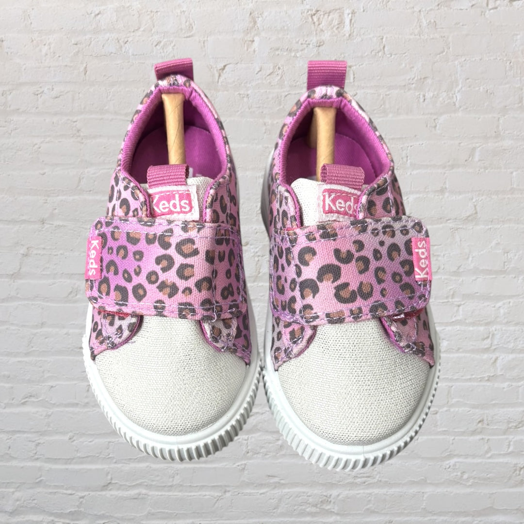 Pink and brown leopard print sneakers with Velcro closures from Keds, featuring white soles.