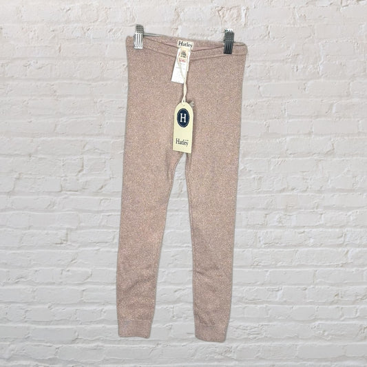 New Hatley sparkle leggings in pink with tags attached, displayed against a white brick wall.