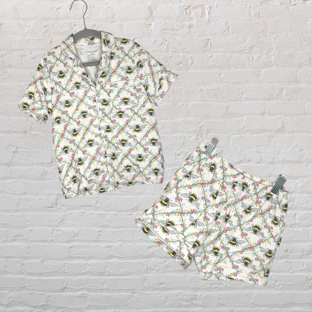 White short-sleeve pajama set with bee and floral print, including a button-up shirt and shorts.
