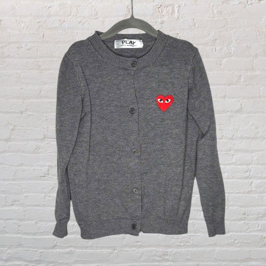 Gray cardigan with red heart logo on left chest by Comme des Garçons Play.