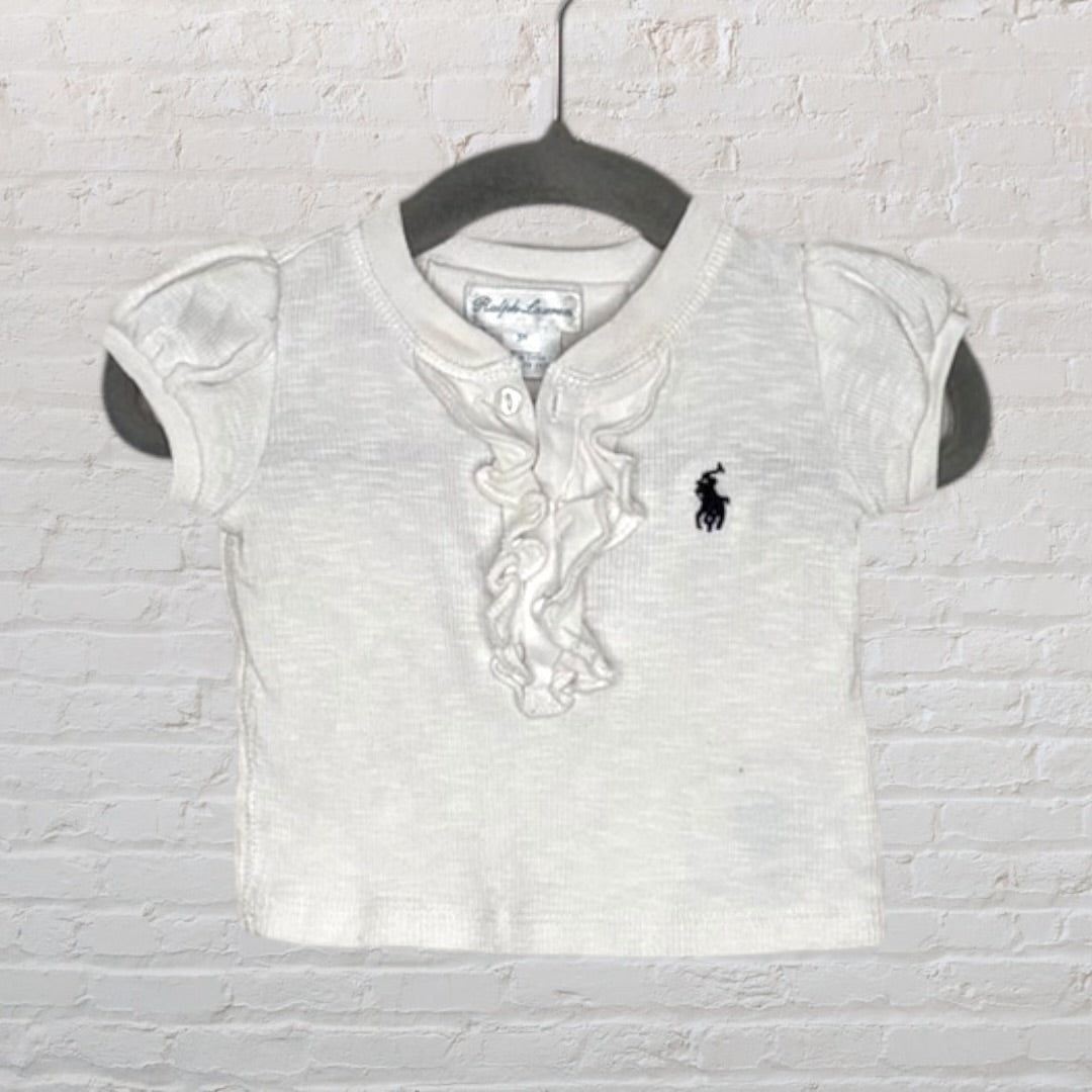 White Ralph Lauren polo shirt with ruffled front and embroidered logo, featuring short sleeves.
