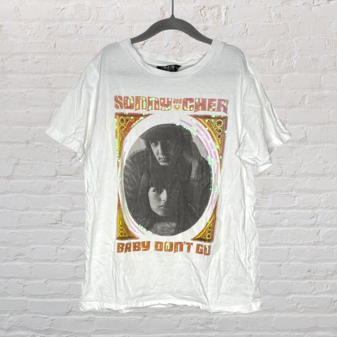 White T-shirt featuring a Sonny and Cher graphic with 'Baby Don't Go' text and decorative border, hanging on a hanger.
