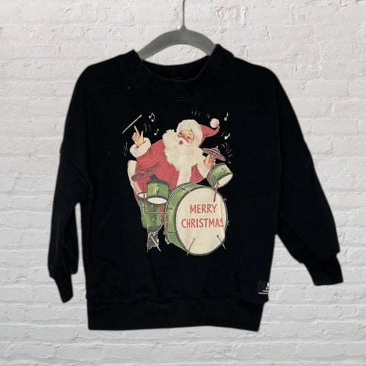 Black sweater featuring a print of Santa Claus playing drums with 'Merry Christmas' text.
