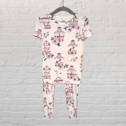 Two-piece pajama set with carousel horse and floral print in pink and white.
