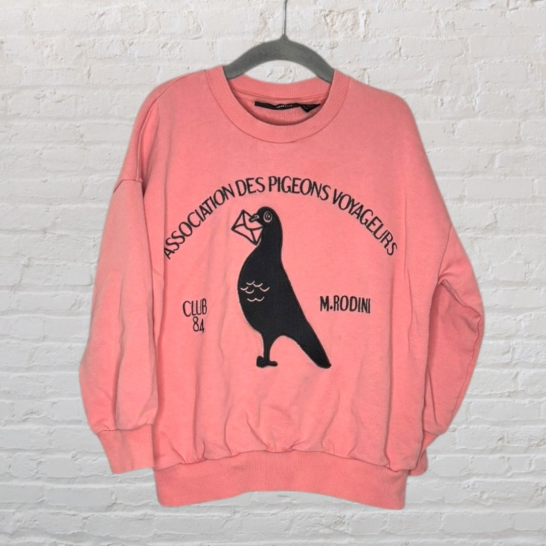 Pink sweatshirt with a pigeon graphic and 'Association des Pigeons Voyageurs' text, by Mini Rodini.