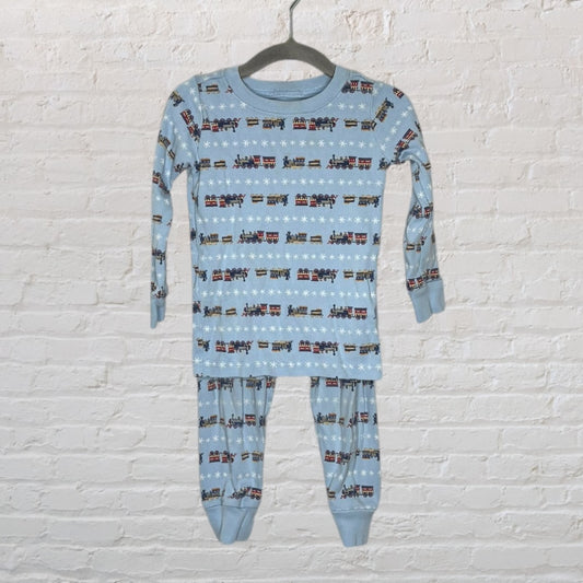 Light blue long-sleeve pajama set with colorful train patterns and snowflakes, hanging on a hanger.