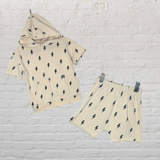 Beige outfit set featuring a short-sleeve hoodie and shorts, both adorned with black lightning bolt prints.