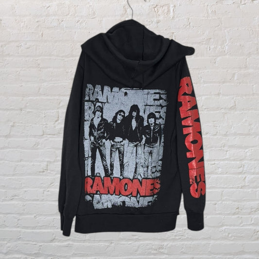 Black hoodie with iconic Ramones band graphic on the back and red 'RAMONES' text on the sleeve.