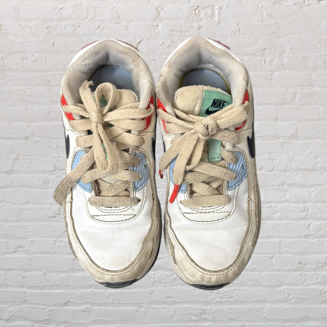 White sneakers with navy, red, and mint green accents, featuring a classic design with laces.