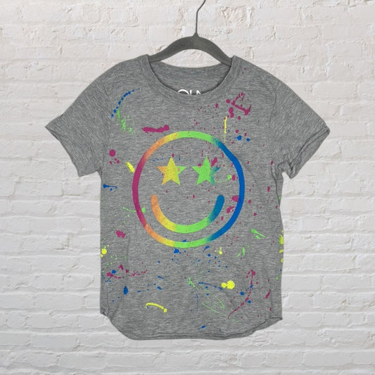 Gray T-shirt with a neon rainbow smiley face and star eyes design, featuring colorful paint splatters.