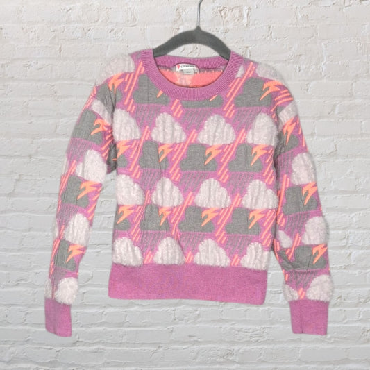 Colorful knit sweater with cloud and lightning pattern in pink, grey, and orange hues displayed on a hanger.
