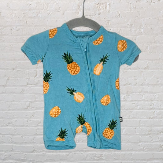 Blue baby romper with yellow pineapple print and a front zipper, hanging on a grey hanger.