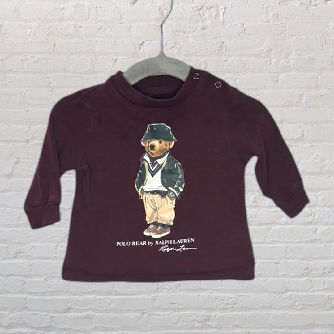 Brown Ralph Lauren Polo Bear sweatshirt featuring the classic bear in a preppy outfit, displayed on a hanger.