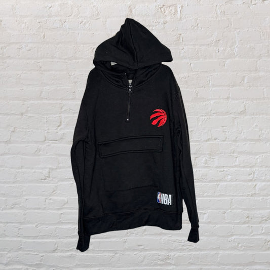 Black NBA hoodie with Toronto Raptors logo, featuring a kangaroo pocket and half-zip front.