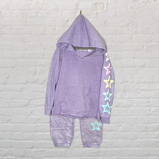 Purple hoodie and joggers set with multicolored stars on sleeve and leg.