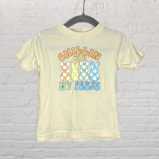 Light yellow T-shirt with the phrase 'Chillin' With My Peeps' and colorful bunny graphics printed on the front.