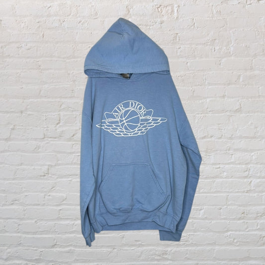 Blue hoodie featuring the Air Dior logo with wings and basketball design on the front.