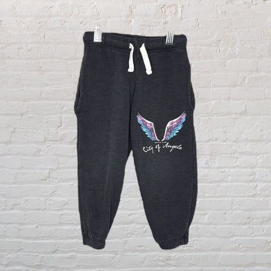 Dark grey jogger pants with a multicolored wing graphic and 'City of Angels' text.