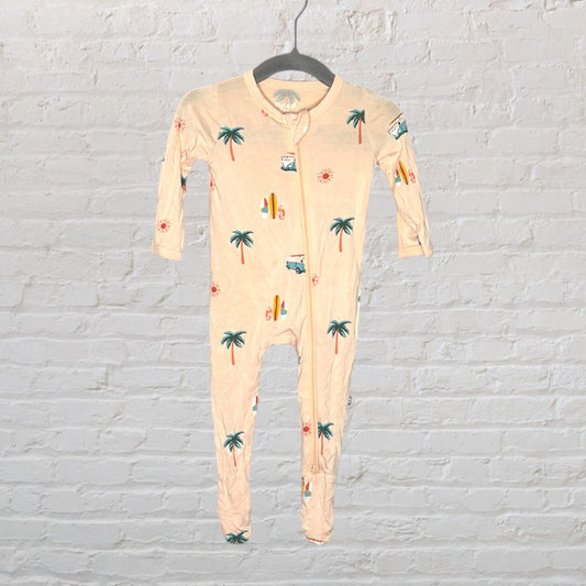 Peach baby onesie with tropical print featuring palm trees, suns, and surfboards, hanging on a black hanger.