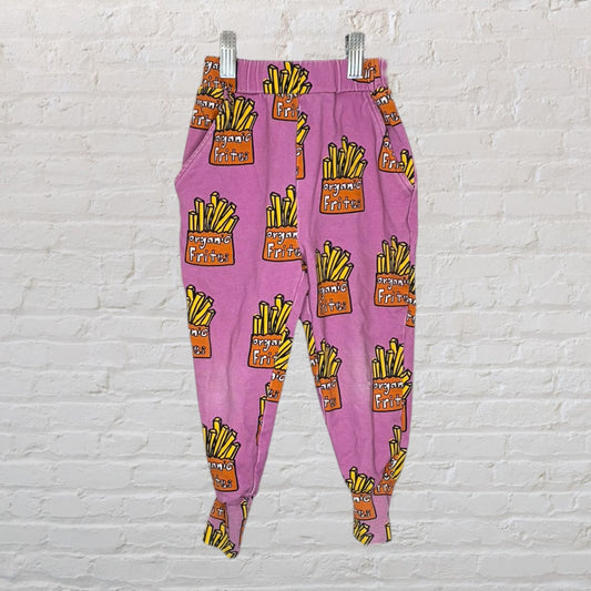 Pink joggers with a repeating 'Organic Frites' graphic print, featuring yellow fries in orange containers.