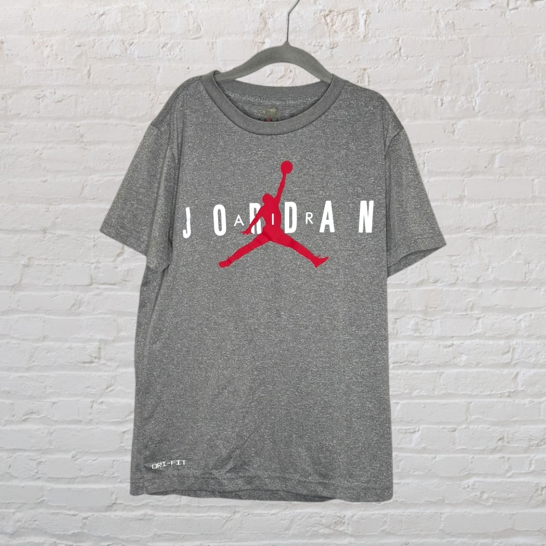Grey Jordan Dri-FIT T-shirt with red Jumpman logo and white lettering, hanging on a black hanger.