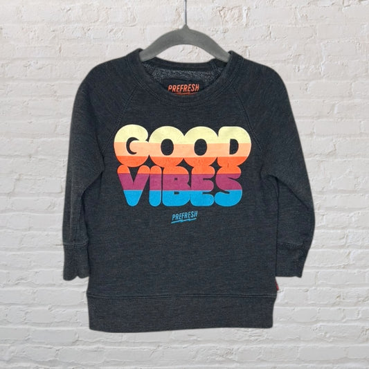 Dark grey sweatshirt with 'Good Vibes' in colorful gradient letters, by Prefresh, hanging on a hanger.