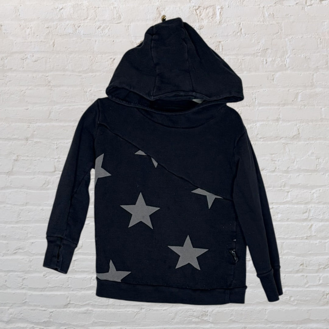 Black hoodie with diagonal grey star prints on the front, displayed against a white brick wall.