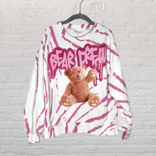 White and pink tie-dye sweatshirt with 'Bear Crew' graphic and bear image, hanging on a black hanger.