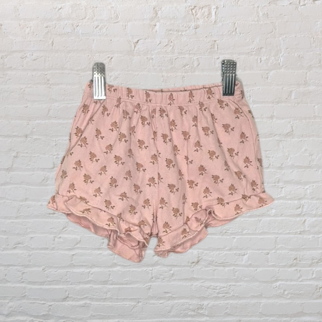 Pink floral print cami and shorts set with ruffle details, displayed on a hanger.