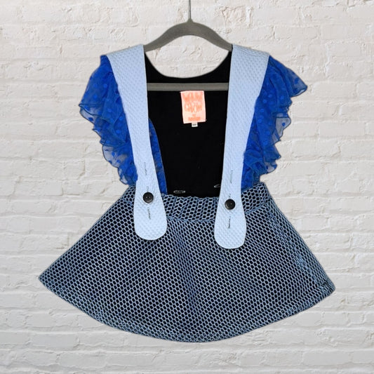 Blue mesh suspender skirt outfit with black top and blue ruffle sleeves, by Malu Chon, hanging on a hanger.