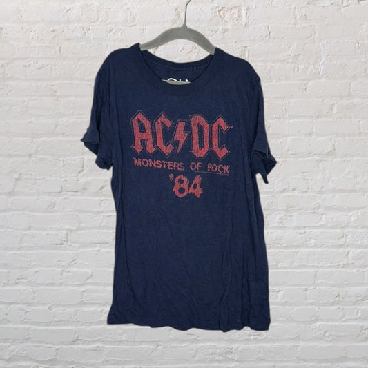 Vintage navy AC/DC t-shirt with red 'Monsters of Rock '84' graphic hanging on a hanger.