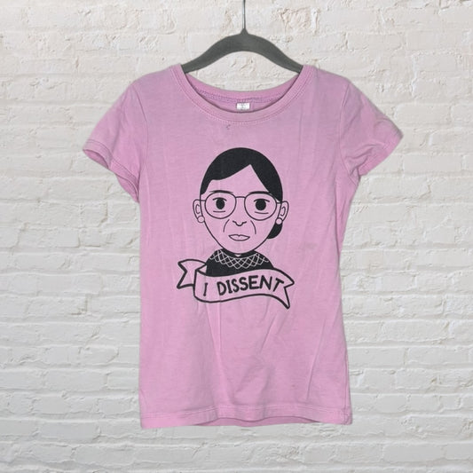 Pink t-shirt with a graphic print of a cartoon character and 'I Dissent' banner.