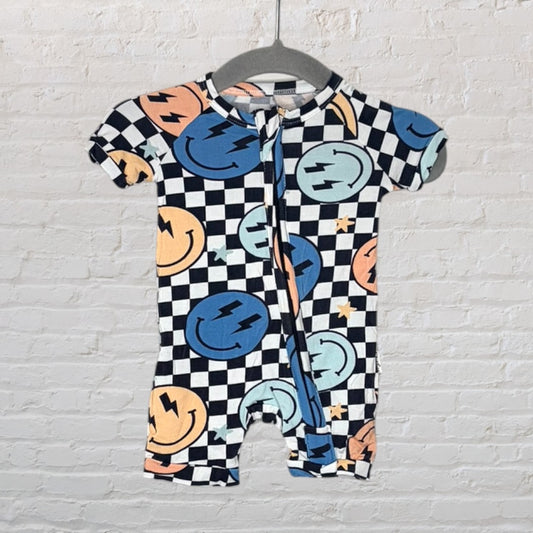 Black and white checkered romper with colorful smiley faces and lightning bolts, displayed on a hanger.