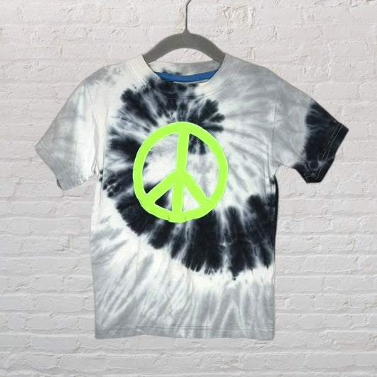 Unisex tie-dye T-shirt in black and white with a large neon green peace sign design on the front, displayed on a hanger.